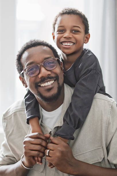 istock Father and son having great time on the livingroom 2206262092
