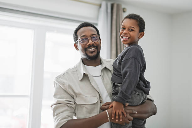 istock Father and son having great time on the livingroom 2206262095