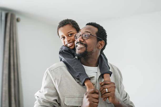 istock Father and son having great time on the livingroom 2206262099