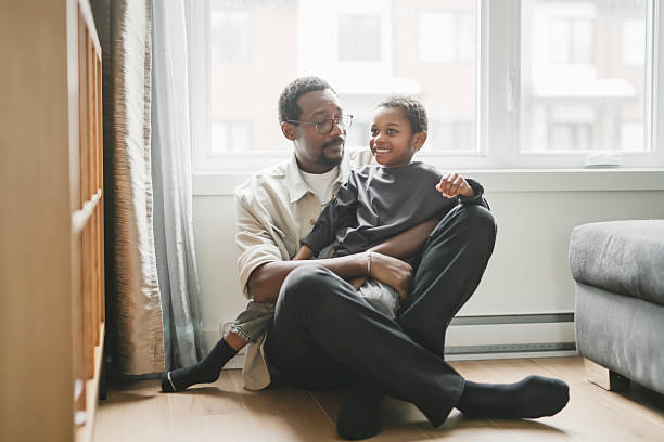 istock Father and son having great time on the livingroom 2206262197