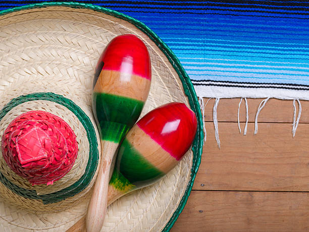 istock Maracas, serape and Mexican hat on wooden table. Cinco de mayo, copy space 2206265080