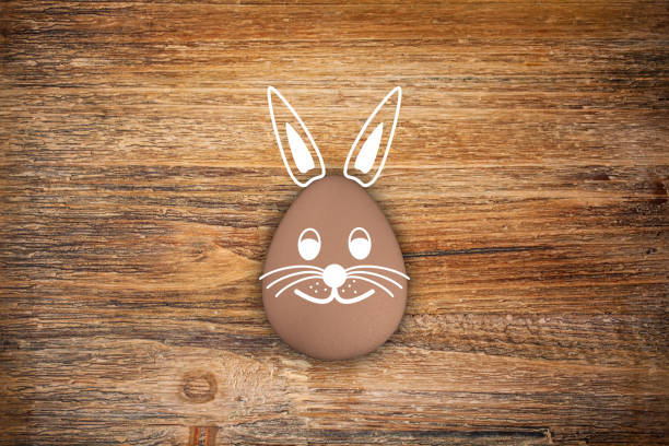 3d render of brown egg with easter bunny face on rustic wood - background - happy easter