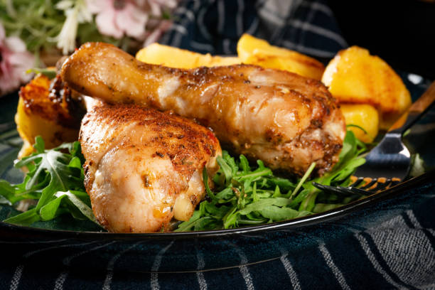 istock Baked chicken drumsticks with potatoes. 2206266478