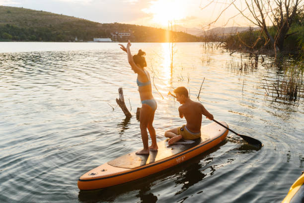 istock Teenagers Splash and Play on a Summer Paddleboarding Adventure 2206266526