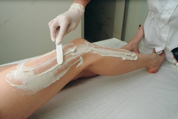 istock Application of Hair Removal Cream on a Client's Leg in a Spa Setting 2206267256