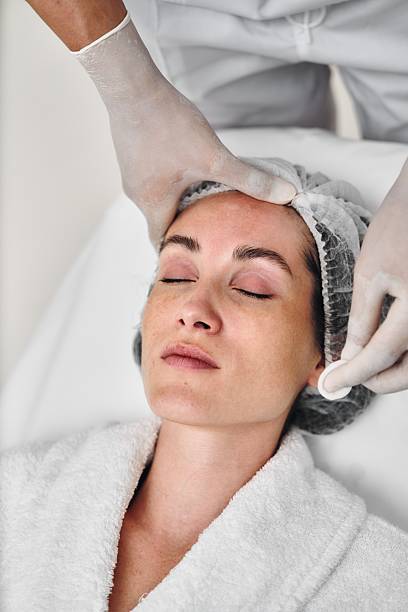 istock Woman experiencing a facial treatment in a serene spa setting 2206269821