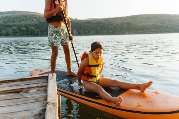 istock Children Ready for a Paddleboarding Adventure on a Calm Lake 2206271144