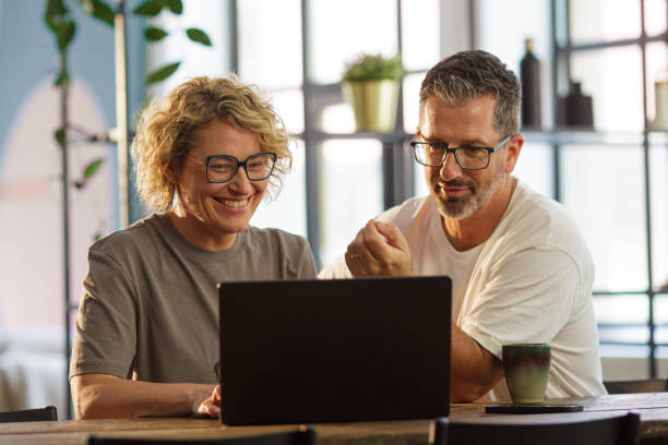 istock Happy Couple Working from Home Together on a Laptop 2206272000