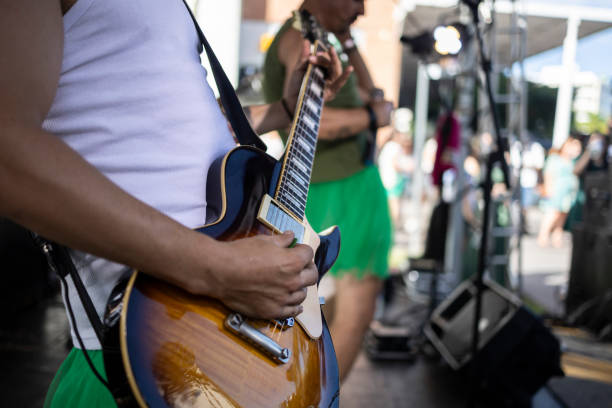istock A person playing guitar at a concert during the day 2206274089