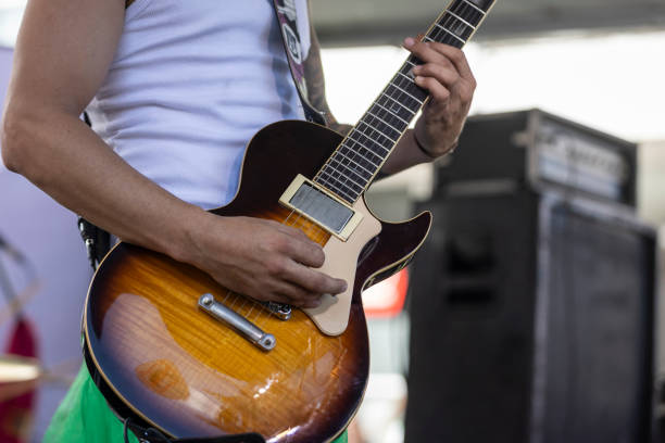 istock A person playing guitar at a concert during the day 2206274193