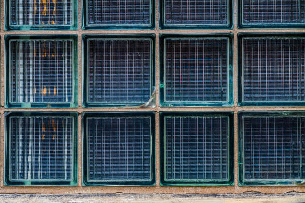 glass block wall with textured surface and visible crack.