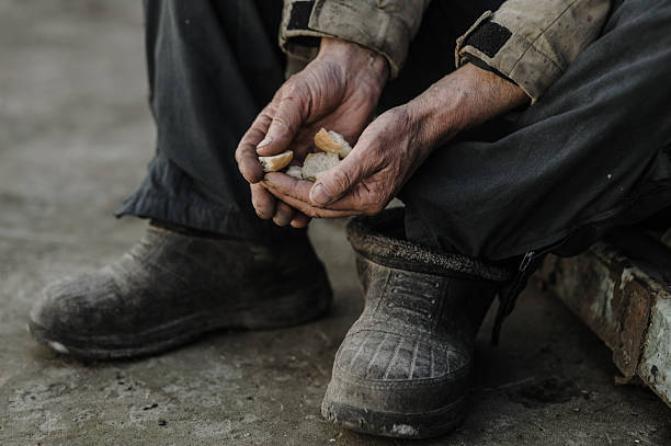 istock The trembling hands carefully hold the last bits of bread 2206276569