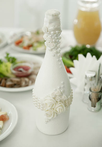istock Decorated wedding champagne bottle on a festive table 2206276748