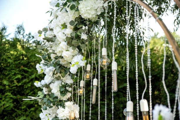 istock Wedding arch decorated with white flowers and lights 2206277384