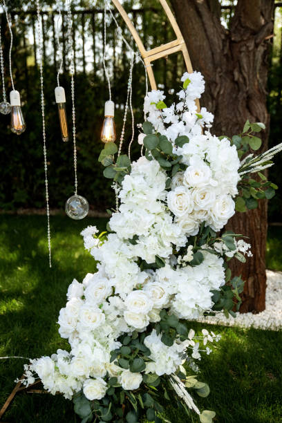istock White floral wedding arch with hanging lights 2206277388