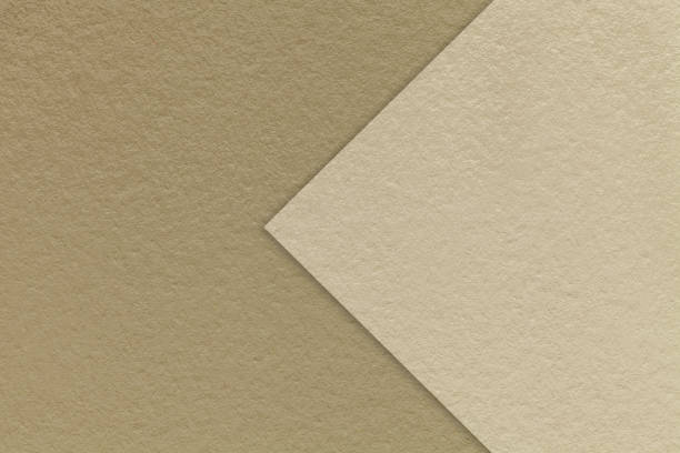 istock Texture brown paper background, half two colors with beige arrow, macro. Structure craft sand cardboard. 2206277637