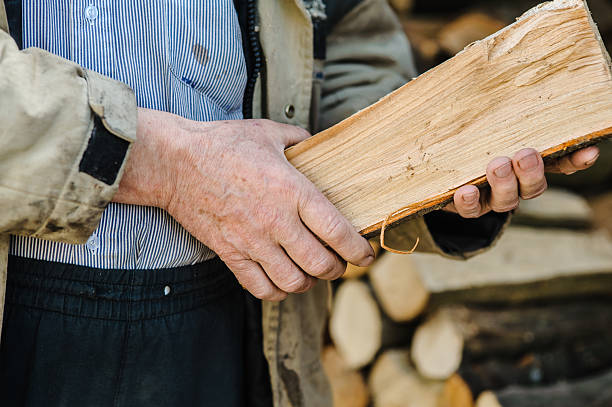 istock Calloused hands hold split wood tightly 2206278489