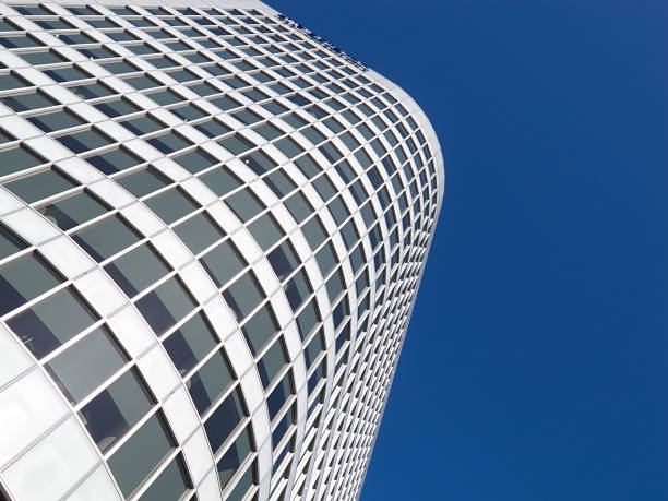istock Modern architectural building with reflective glass surface against clear blue sky 2206278652