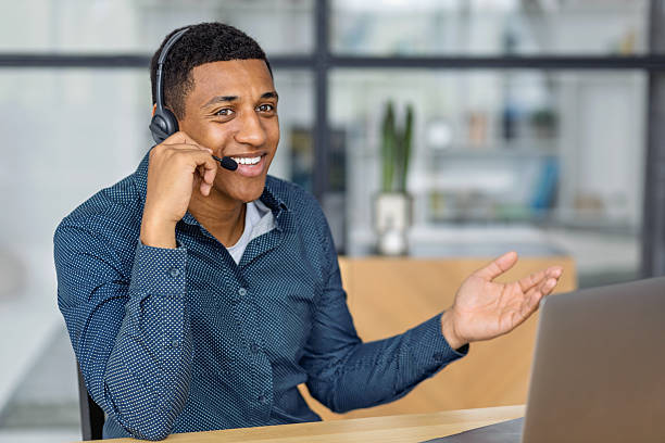 istock Smiling businessman in headset having online conversation 2206278822
