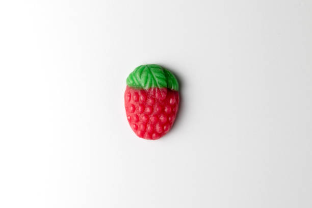 Gummy candy shaped like a strawberry on a white background