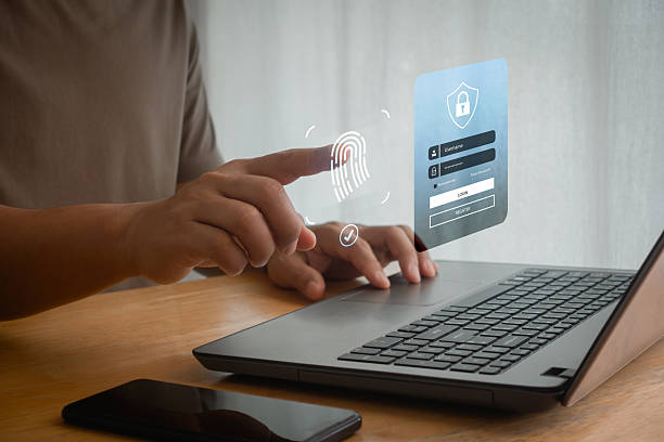 istock Virtual fingerprint scan on a laptop while finger touch scanning for access identity with digital ID biometric identification. Cyber security password, privacy data protection technology for business. 2206281296