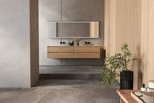 istock Minimalist bathroom interior with floating wooden vanity, rectangular mirror, concrete floor, and potted plant, featuring natural wood and neutral tones. 3D rendering. 2206281570