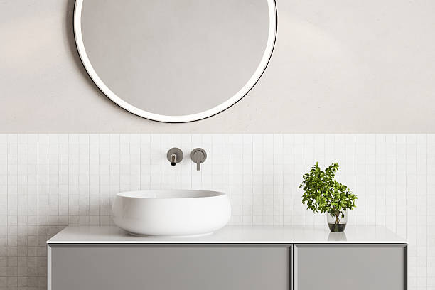 istock 3D render close up perspective blank empty space on ceramic vanity unit counter top in the bathroom with white ceramic porcelain sink with faucet, morning sunlight, wall, Elegance 2206281577