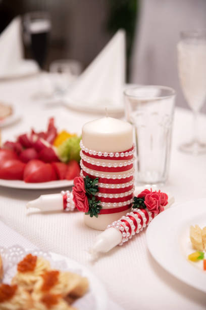istock Decorated candle with red and white stripes on table 2206281624