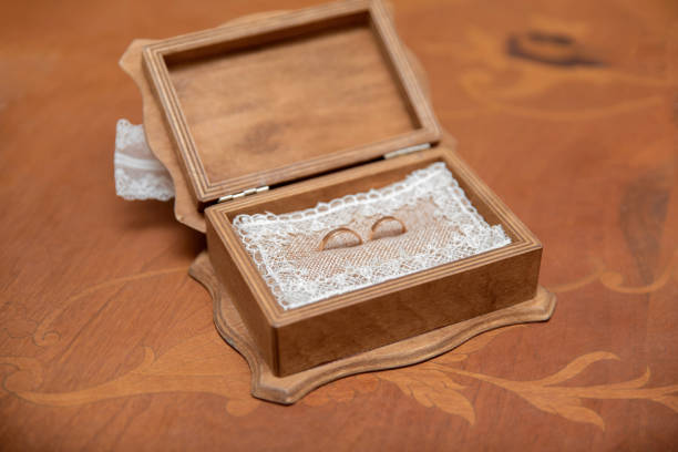 Wooden ring box with wedding rings inside