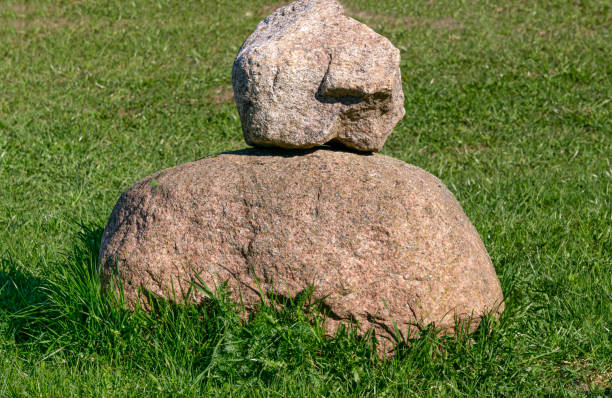 istock Two large granite stones in a field on the grass. 2206282955