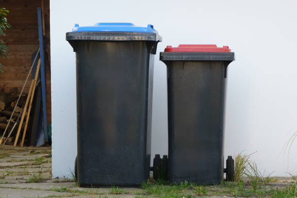 istock Garbage cans in front of a wall – concept for waste separation, recycling and sustainable waste disposal 2206285079