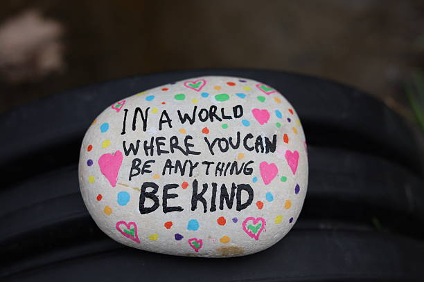 istock In a world be anything be kind kindness rock on water runoff pipe closeup 2206285604