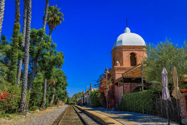 istock San Juan Capistrano domed bell tower overlooks train tracks framed by palm trees 2206286023