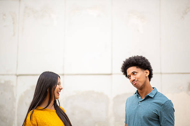 istock young couple standing by white wall together 2206286695