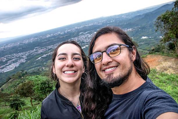 istock Smiling couple enjoying a sunset, taking a close-up selfie in a mountain setting with warm lighting. A moment of happiness and connection 2206287077