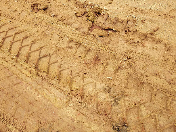 istock tire tracks on the dirt road 2206288542