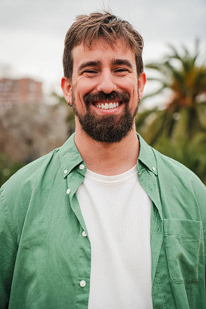 A happy man with a delightful smile showcasing his joyful demeanor while engaging in a friendly interaction that exudes warmth and positivity, capturing the essence of uplifting moments in life.