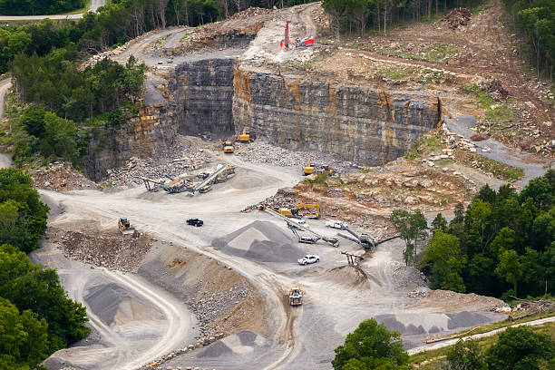 A yellow wheel loader is working in gravel pit