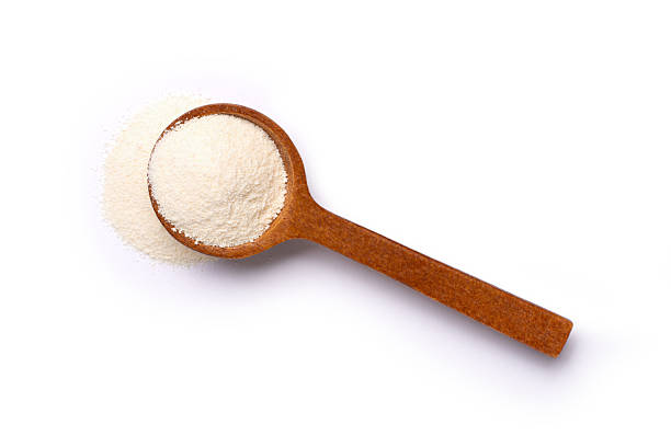 Collagen powder in spoon isolated on white background