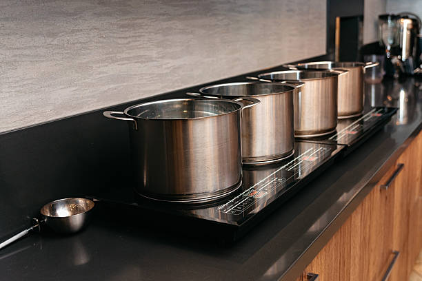 istock Stainless steel pots on modern induction stove 2206317430