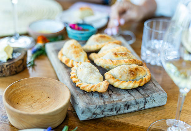 Baked empanadas on wooden board