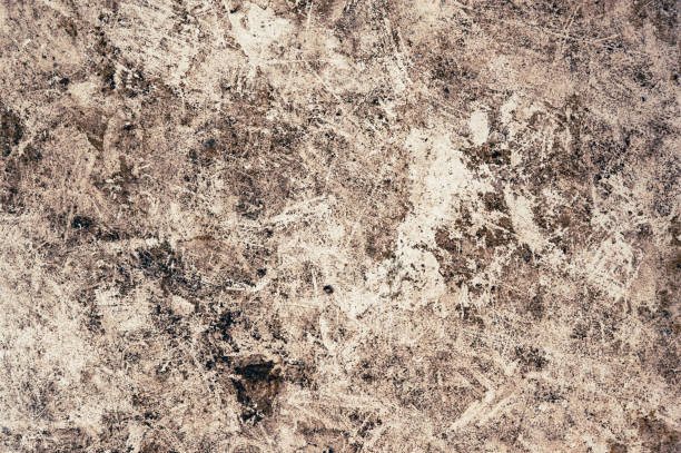 An abstract background featuring a textured surface with scratches and stains in earthy tones. Perfect for creative projects, wallpapers, and artistic endeavors.