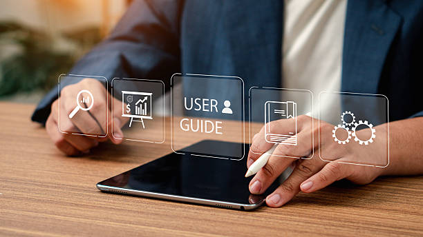 istock User manual guide concept, Online instruction manual and strategy advice. Businessman using laptop with user manual icon and virtual AI for business service 2206326951