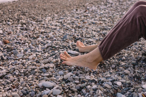 istock Relaxing by the riverbank with bare feet on smooth pebbles during a sunny afternoon 2206329048