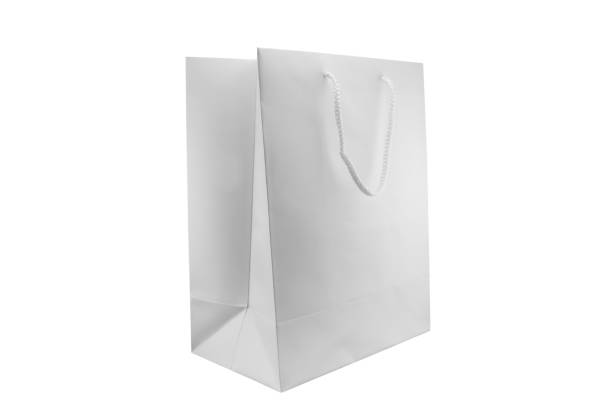 Side view white empty blank disposable paper shopping bag isolated on white background. Paper bag isolated. Paper package