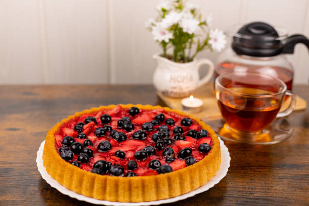 Berry pie and tea on the table. Dessert for tea. Berry pie. Strawberry pie on the table. High quality photo
