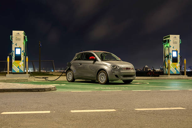 A grey 2022 Fiat 500 EV electric car at EV station stock photo