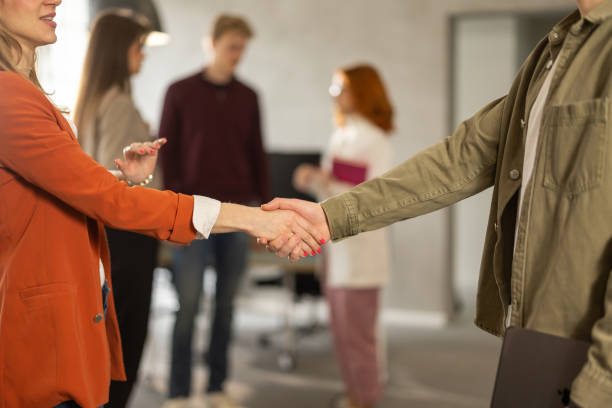 istock Businesspeople handshaking in modern office 2206334771