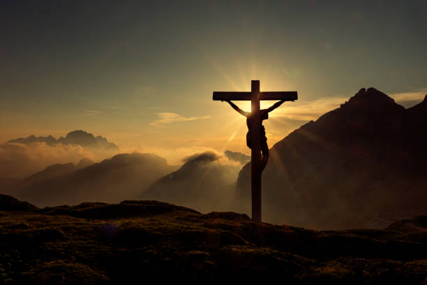 istock Jesus Christ on the Cross with Dramatic Sunset 2206334795