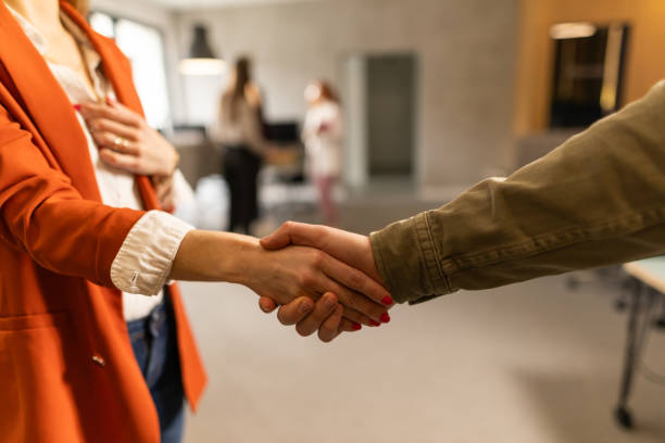 istock Businesspeople handshaking in modern office 2206335218